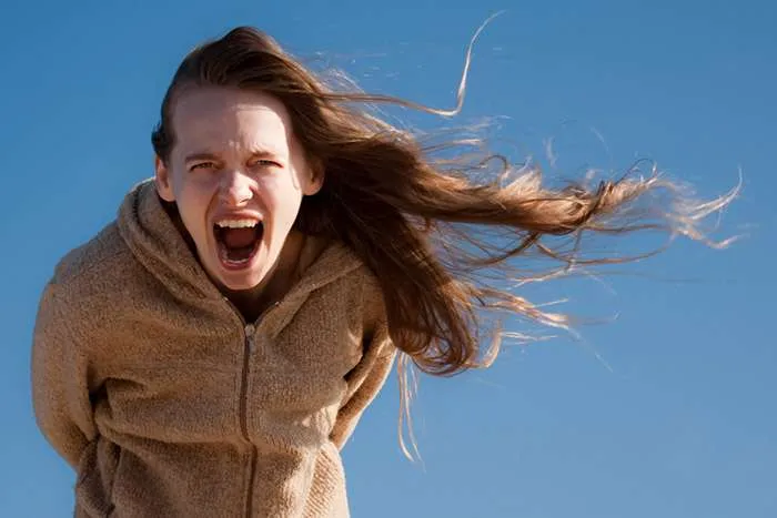 Woman with long hair screaming