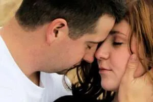 Man and woman holding each other close