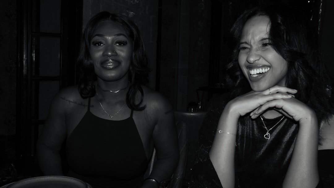 Two women laughing together at a table.
